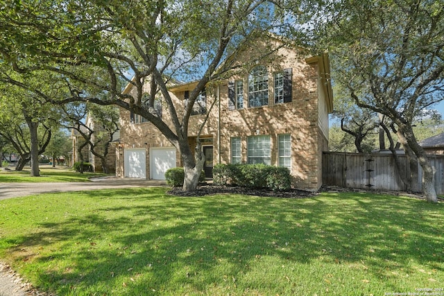 view of front facade featuring a front lawn and a garage