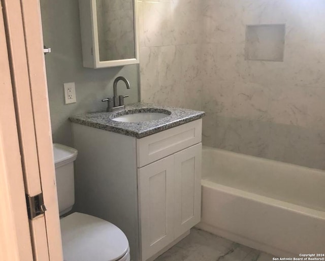 full bathroom featuring tub / shower combination, vanity, and toilet