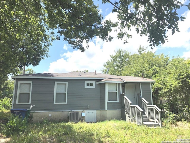 rear view of property featuring central AC