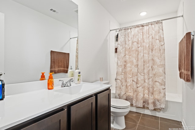 full bathroom featuring toilet, tile patterned flooring, vanity, and shower / tub combo with curtain