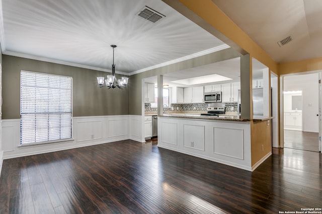 kitchen featuring pendant lighting, tasteful backsplash, dark hardwood / wood-style floors, appliances with stainless steel finishes, and white cabinetry