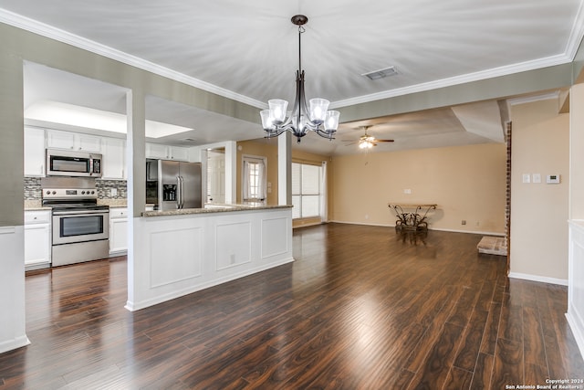 kitchen featuring appliances with stainless steel finishes, dark wood-type flooring, hanging light fixtures, and white cabinetry