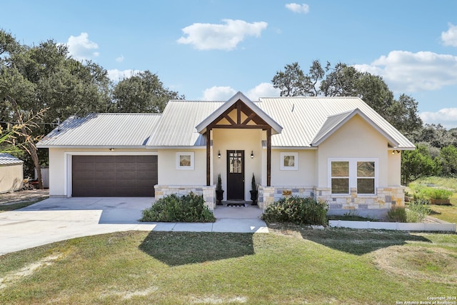 view of front of home with a front yard and a garage