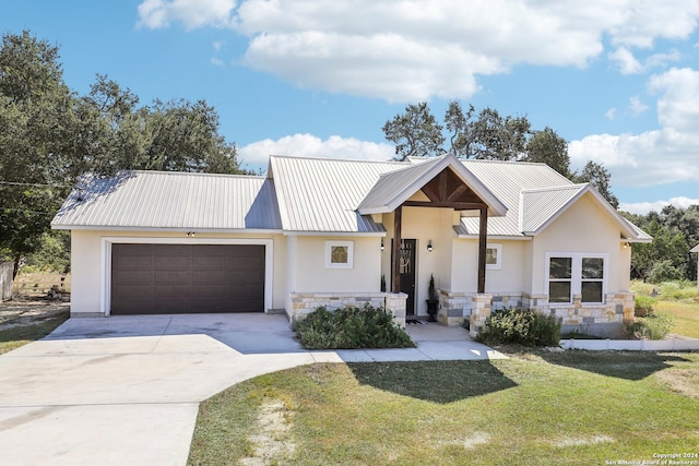 view of front of property with a garage and a front yard