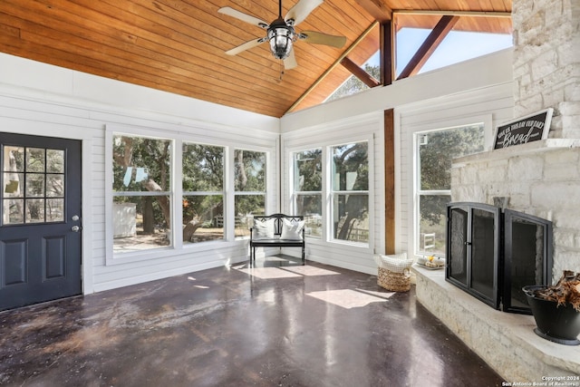 unfurnished sunroom featuring lofted ceiling with beams, a healthy amount of sunlight, and wood ceiling