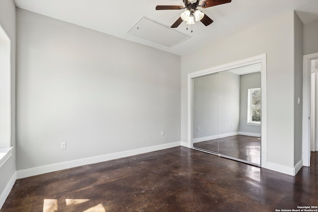 unfurnished bedroom with ceiling fan and a closet