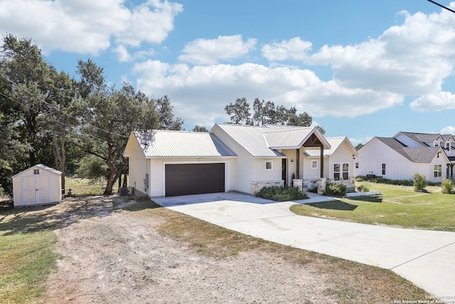 modern inspired farmhouse featuring a garage and a front yard