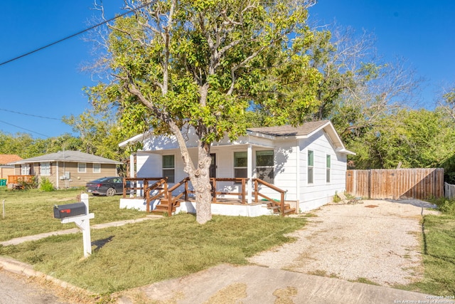 bungalow-style home with a front lawn