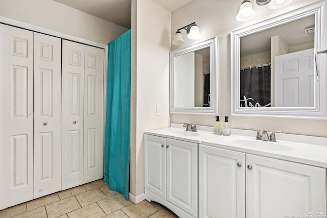 bathroom featuring tile patterned flooring and vanity