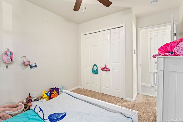 carpeted bedroom with a closet and ceiling fan