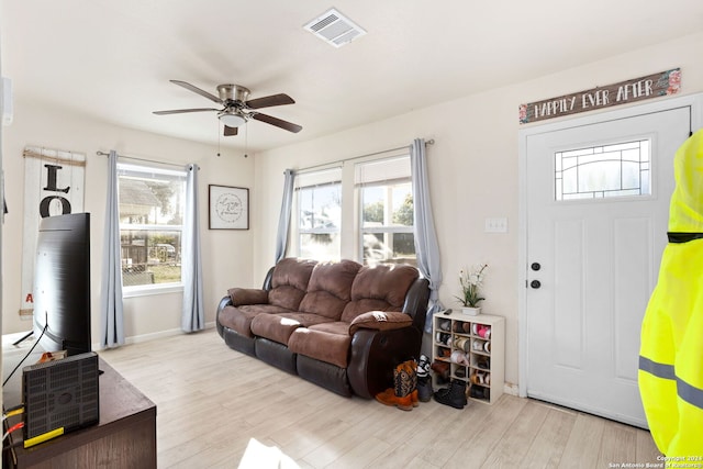 living room with ceiling fan and light hardwood / wood-style flooring