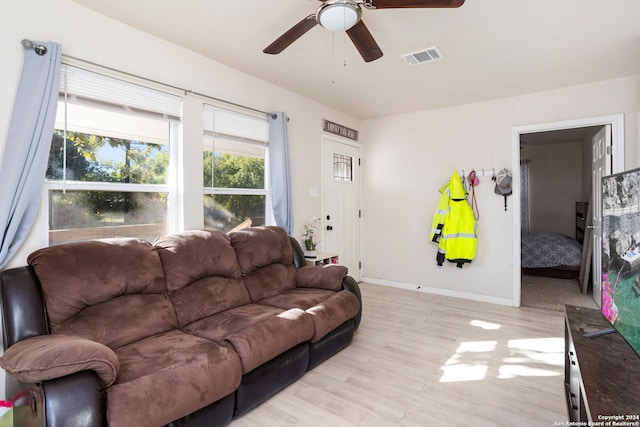 living room featuring ceiling fan and light hardwood / wood-style floors