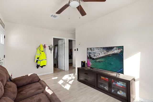 living room featuring light hardwood / wood-style floors and ceiling fan