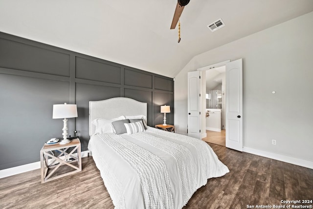 bedroom featuring lofted ceiling, wood-type flooring, ensuite bathroom, and ceiling fan