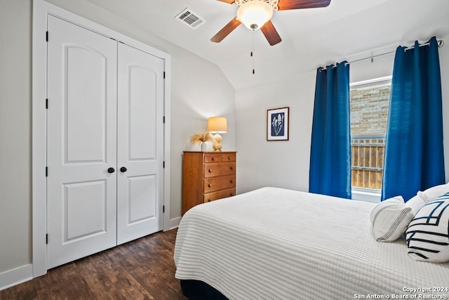 bedroom with vaulted ceiling, ceiling fan, dark wood-type flooring, and a closet