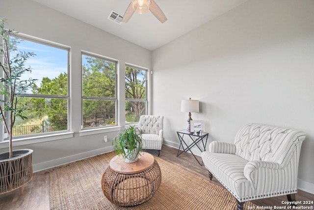 sitting room featuring hardwood / wood-style flooring, ceiling fan, and vaulted ceiling