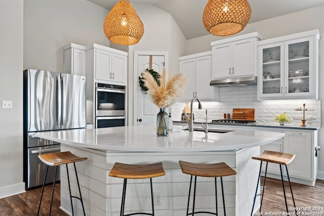 kitchen with white cabinets, sink, a center island with sink, stainless steel appliances, and dark hardwood / wood-style flooring