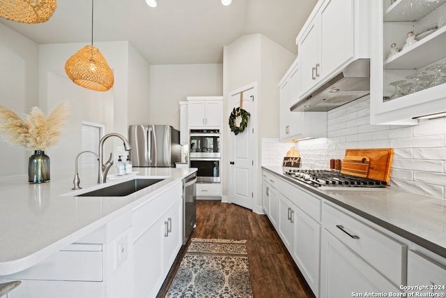 kitchen featuring pendant lighting, dark hardwood / wood-style flooring, sink, stainless steel appliances, and white cabinets