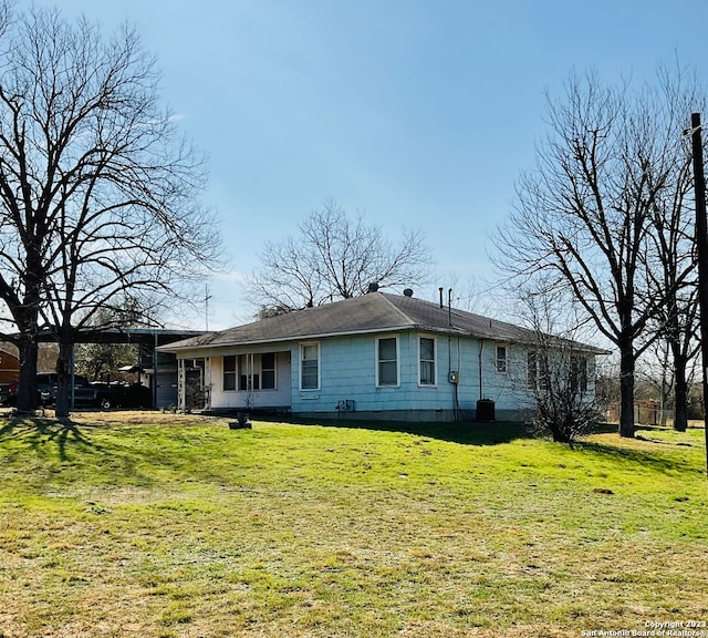 rear view of house with a yard