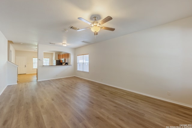 unfurnished living room with light hardwood / wood-style floors and ceiling fan