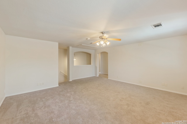 empty room featuring ceiling fan and light carpet