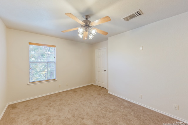 spare room with light carpet and ceiling fan