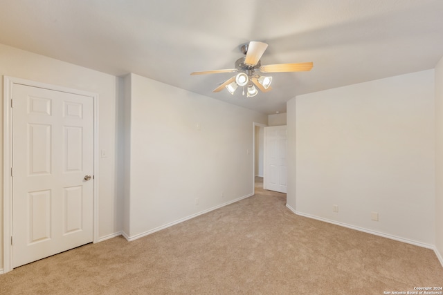 unfurnished room with ceiling fan and light colored carpet