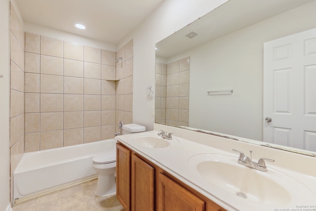 full bathroom with vanity, tile patterned flooring, toilet, and tiled shower / bath