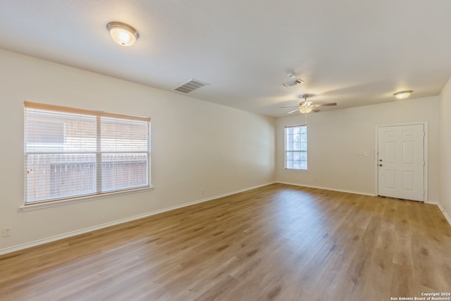 spare room with ceiling fan and light hardwood / wood-style flooring