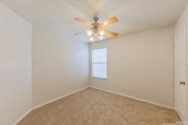 unfurnished room with ceiling fan and light colored carpet