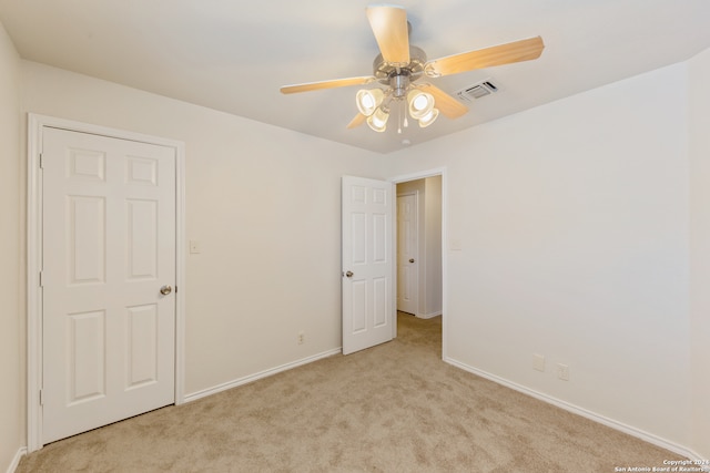 interior space with light carpet and ceiling fan