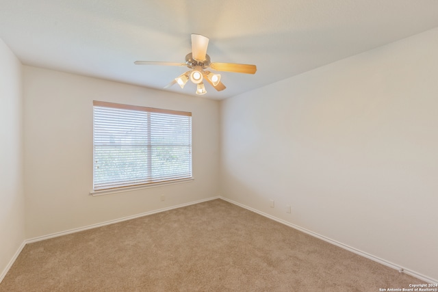 unfurnished room featuring light carpet and ceiling fan