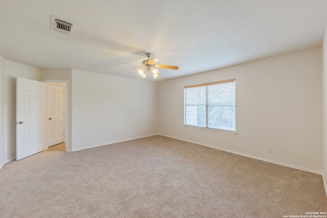 carpeted empty room with ceiling fan