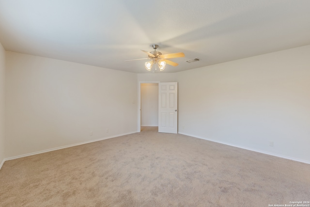 carpeted empty room featuring ceiling fan