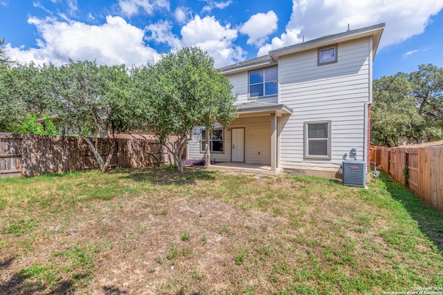 rear view of property featuring a patio and a lawn