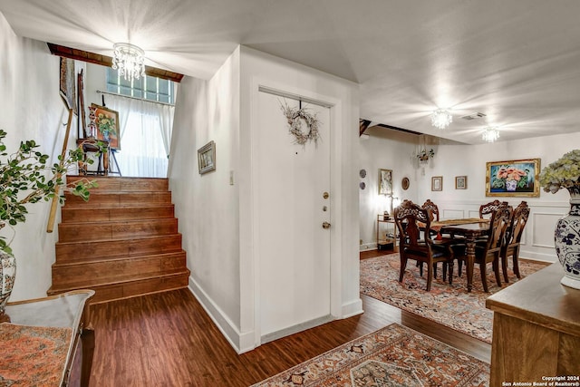 interior space featuring an inviting chandelier and dark hardwood / wood-style flooring