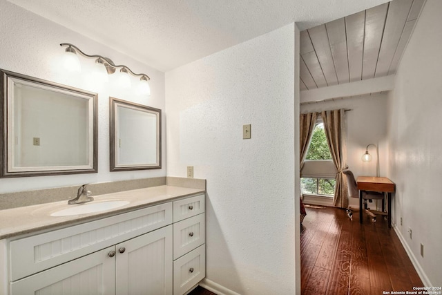 bathroom with vanity, hardwood / wood-style floors, and a textured ceiling