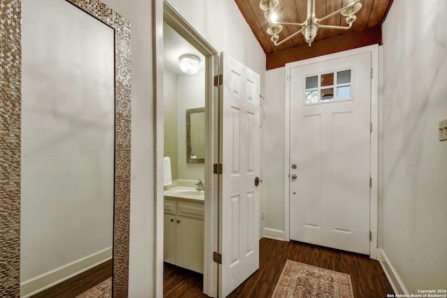 foyer with dark hardwood / wood-style floors and wooden ceiling