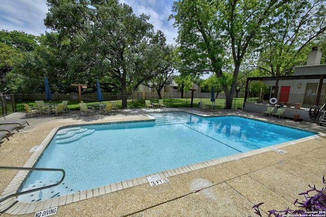 view of swimming pool featuring a patio area