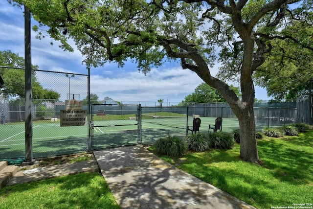 view of sport court featuring a yard