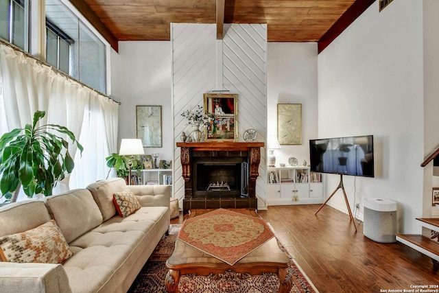 living room with wood ceiling, hardwood / wood-style floors, a high ceiling, and beamed ceiling