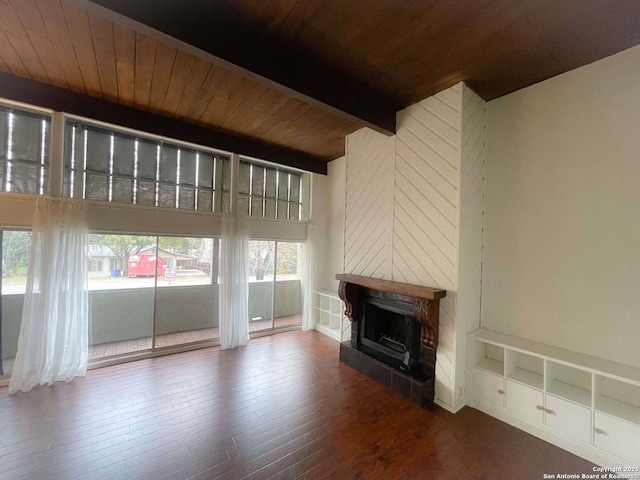 unfurnished living room with hardwood / wood-style flooring, a high end fireplace, wooden ceiling, and beamed ceiling