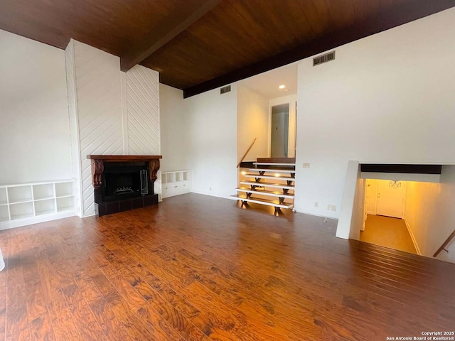 unfurnished living room featuring hardwood / wood-style floors, beam ceiling, and wooden ceiling