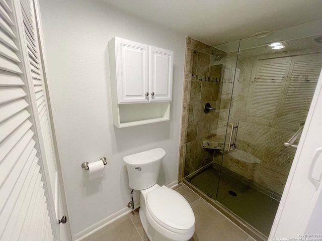 bathroom with tile patterned flooring, walk in shower, and toilet