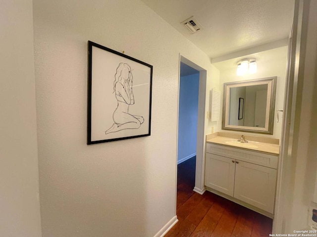 hallway featuring dark hardwood / wood-style flooring and sink