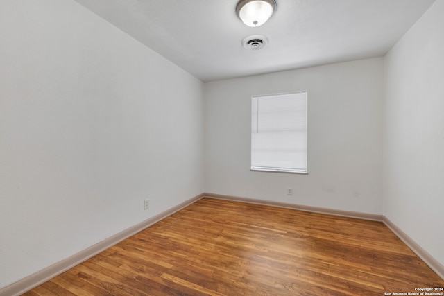 empty room with wood-type flooring