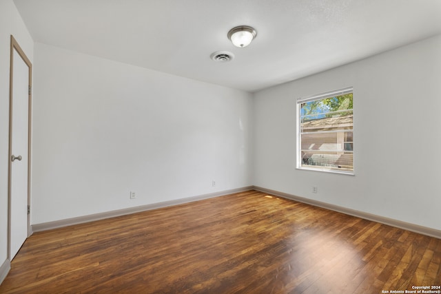 spare room featuring dark wood-type flooring