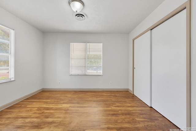 unfurnished bedroom featuring a closet and light hardwood / wood-style floors