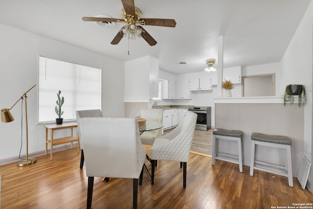 dining area featuring hardwood / wood-style floors and ceiling fan