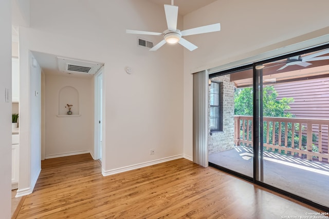 empty room featuring ceiling fan, light hardwood / wood-style flooring, and lofted ceiling